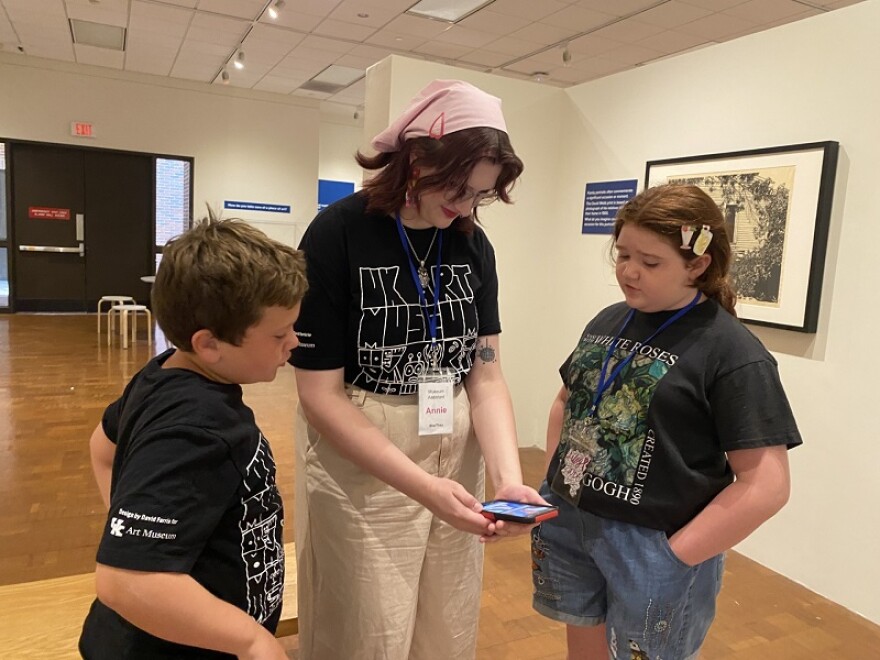 UK Art Museum camp counselor Annie Vikary assists Bentley Yinger and Lilly Ware with a short video they created together for camp.