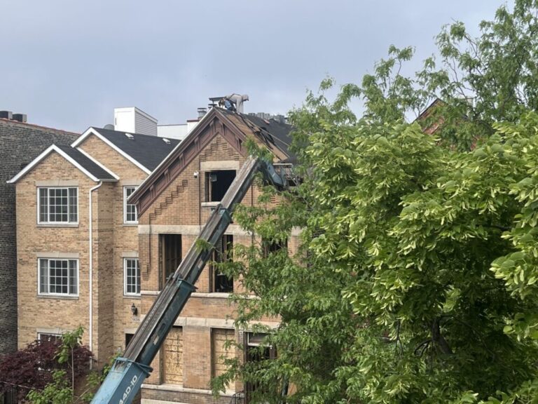 An construction worker on the roof of a
