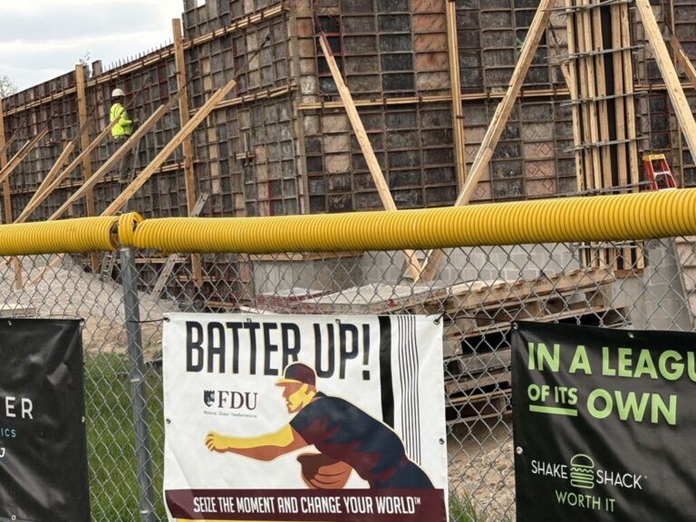 An outdoor construction site behind a chain
