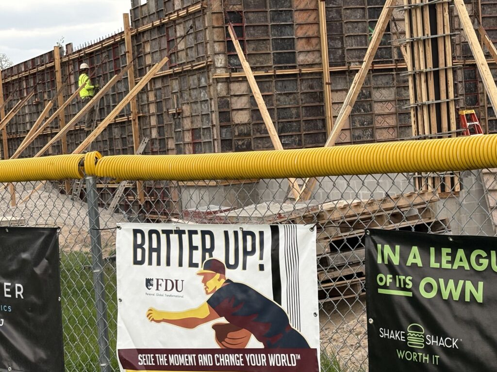 An outdoor construction site behind a chain