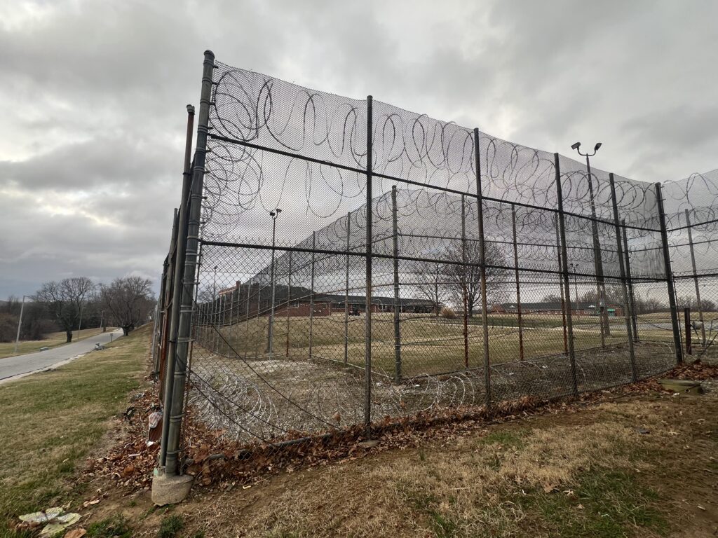 A high chain-link security fence topped