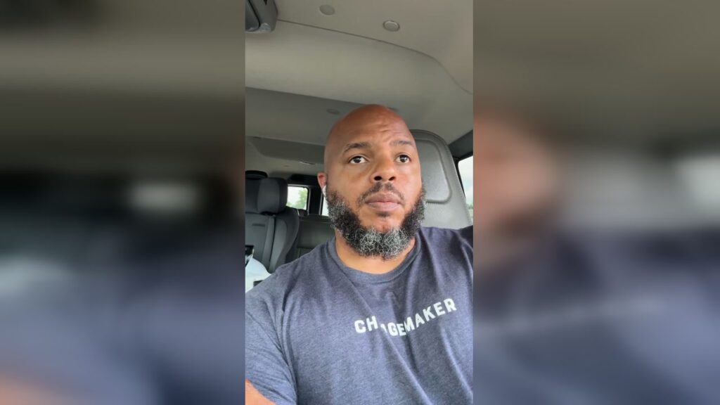 A bald Black man with a graying