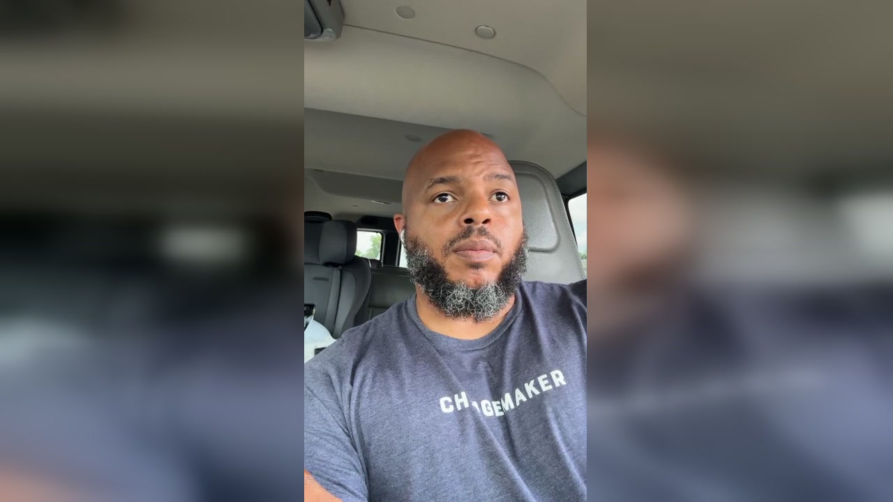 A bald Black man with a graying